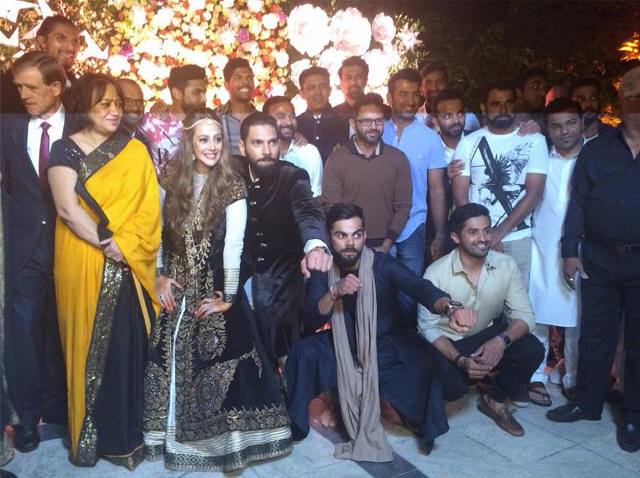 The couple posing with friends at their sangeet. Check out Virat Kohli!